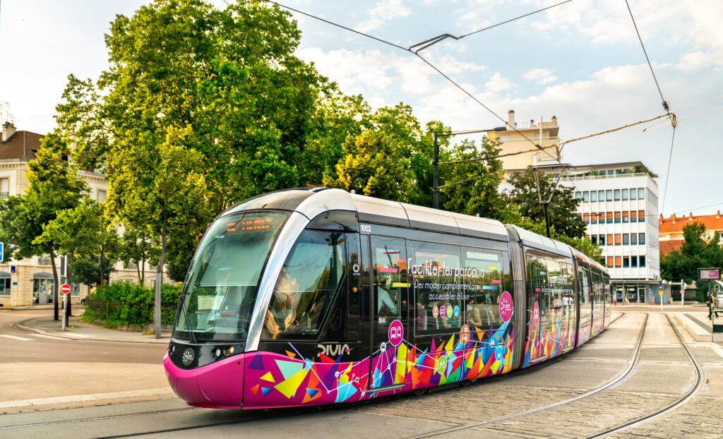 Dijon, France - July 7, 2018: Modern city tram Alstom Citadis 302 on Place de la Republique. The Dijon tram network comprises 37 stations on 2 lines.